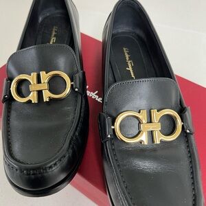 Salvatore Ferragamo Black and Gold Loafers with Elegant Design
